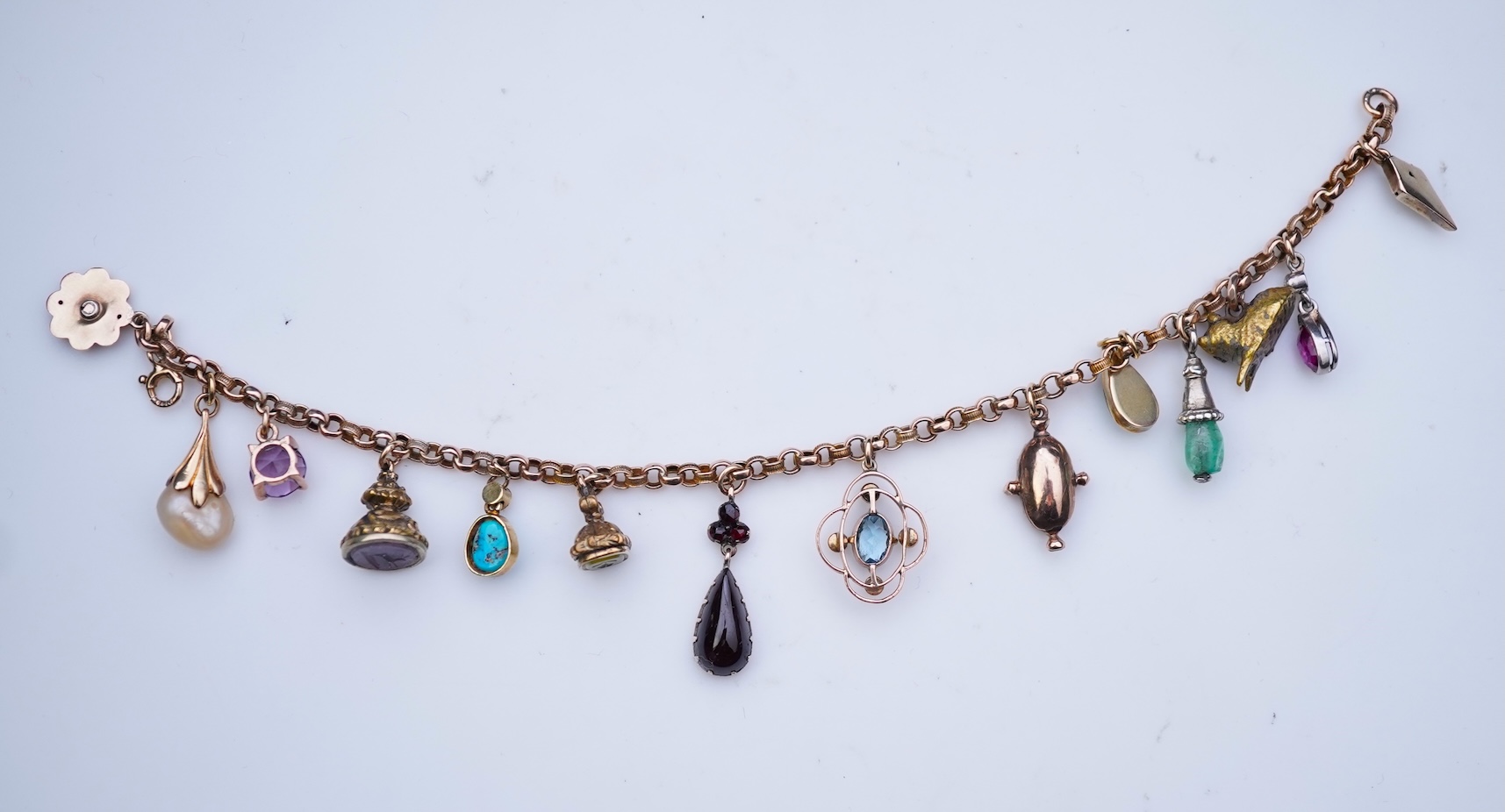 A gem-set charm bracelet, late 19th-early 20th century